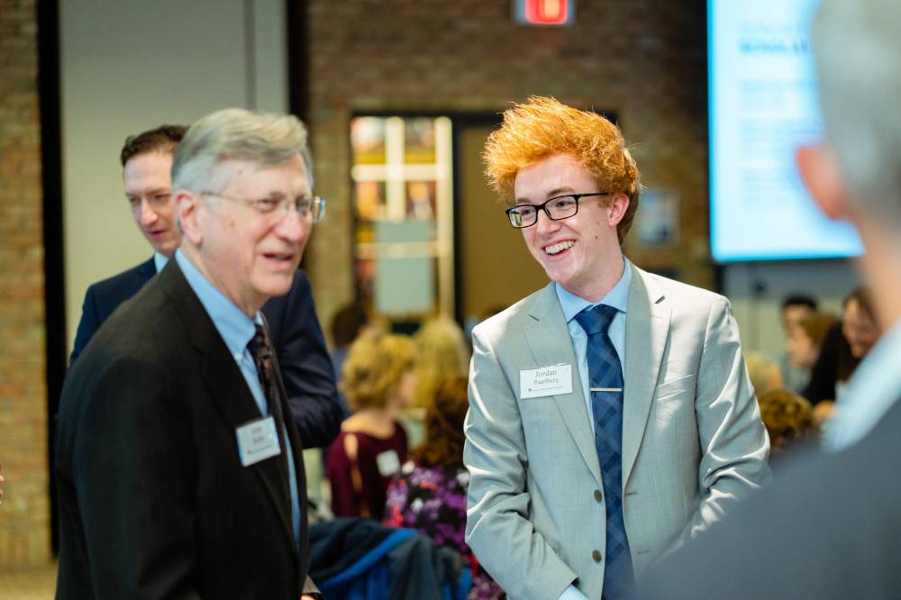 Student laughing with a donor at Scholarship Dinner 2019